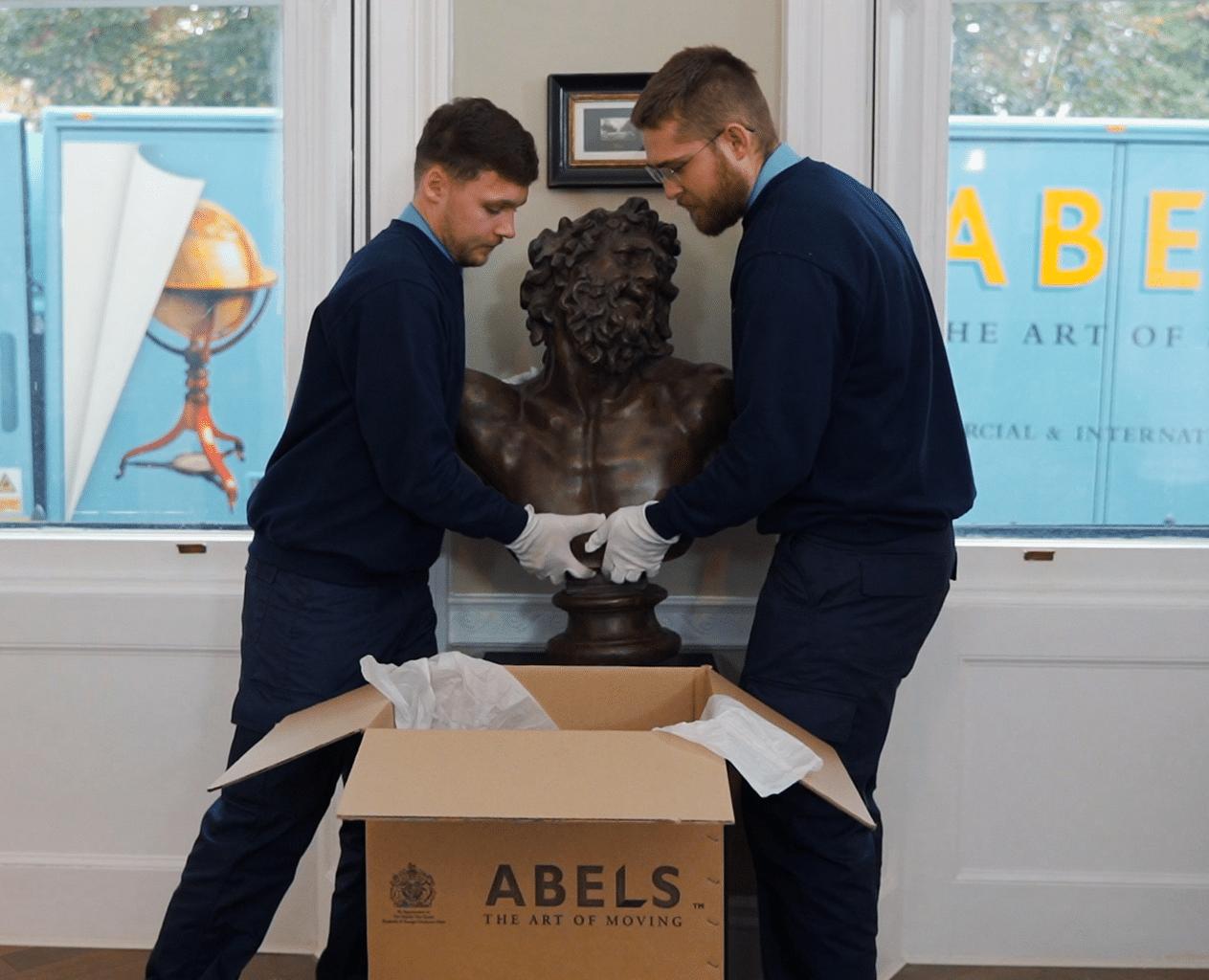 Abels staff handling sculptured art with care, offering safe transport for delicate items across the UK & through our overseas moving company services.