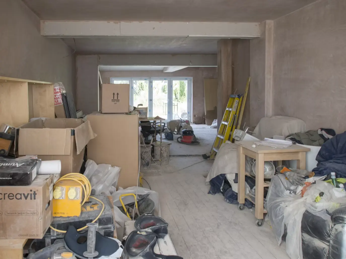 Boxes and furniture in a home undergoing renovation